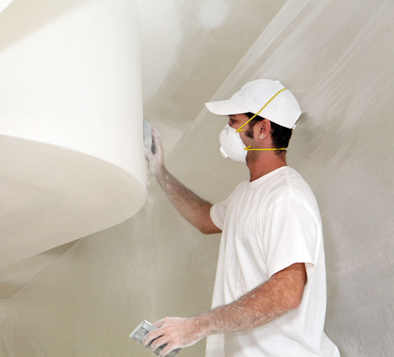 Drywall-sanding Man sanding drywall so it can be painted