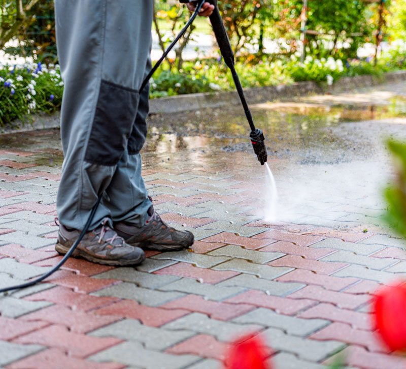 Power-washing someone power washing a patio