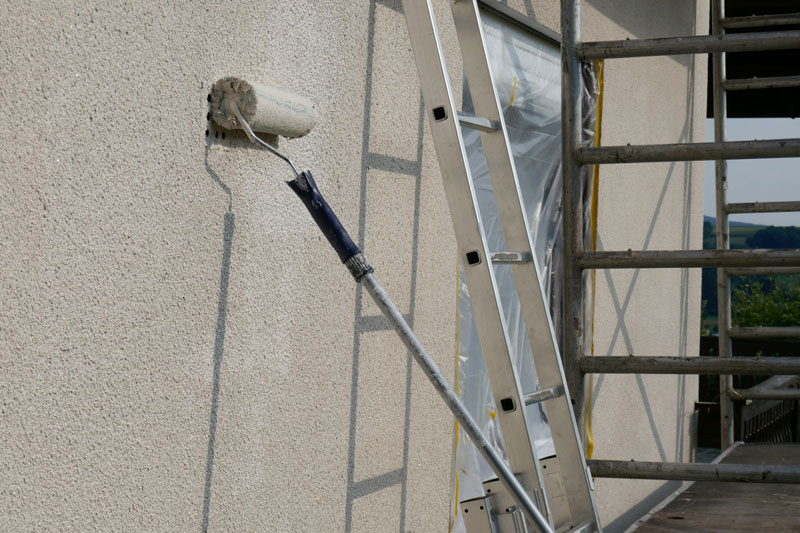 exterior-Painting roller brush painting the exterior of a home